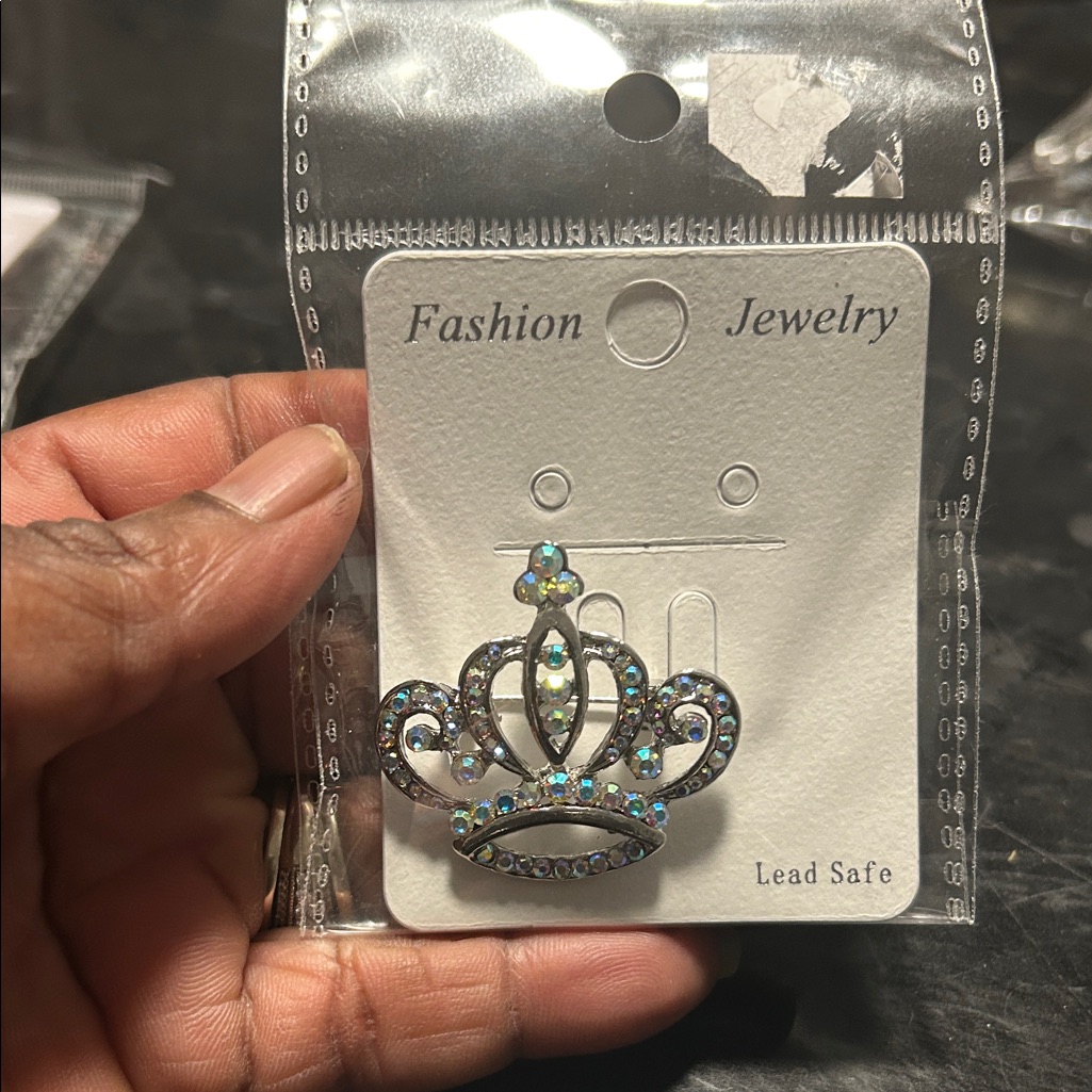 Elegant Silver Crown Brooch With Blue Accents